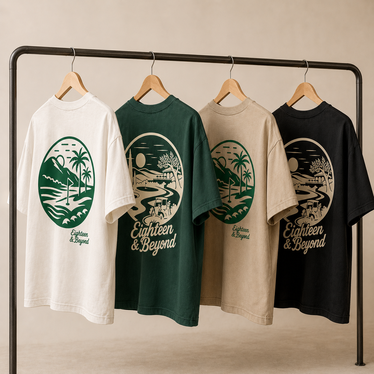 Four Eighteen and Beyond oversized graphic tees hanging on a clothing rack in cream, green, sand and black