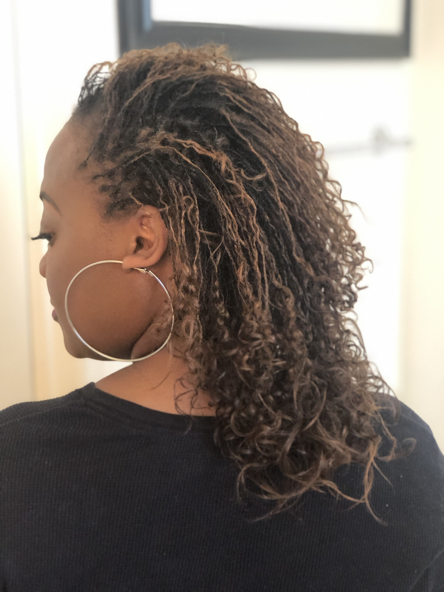 Curly highlighted microlocks with beautiful dimension and movement styled by CandieLocks