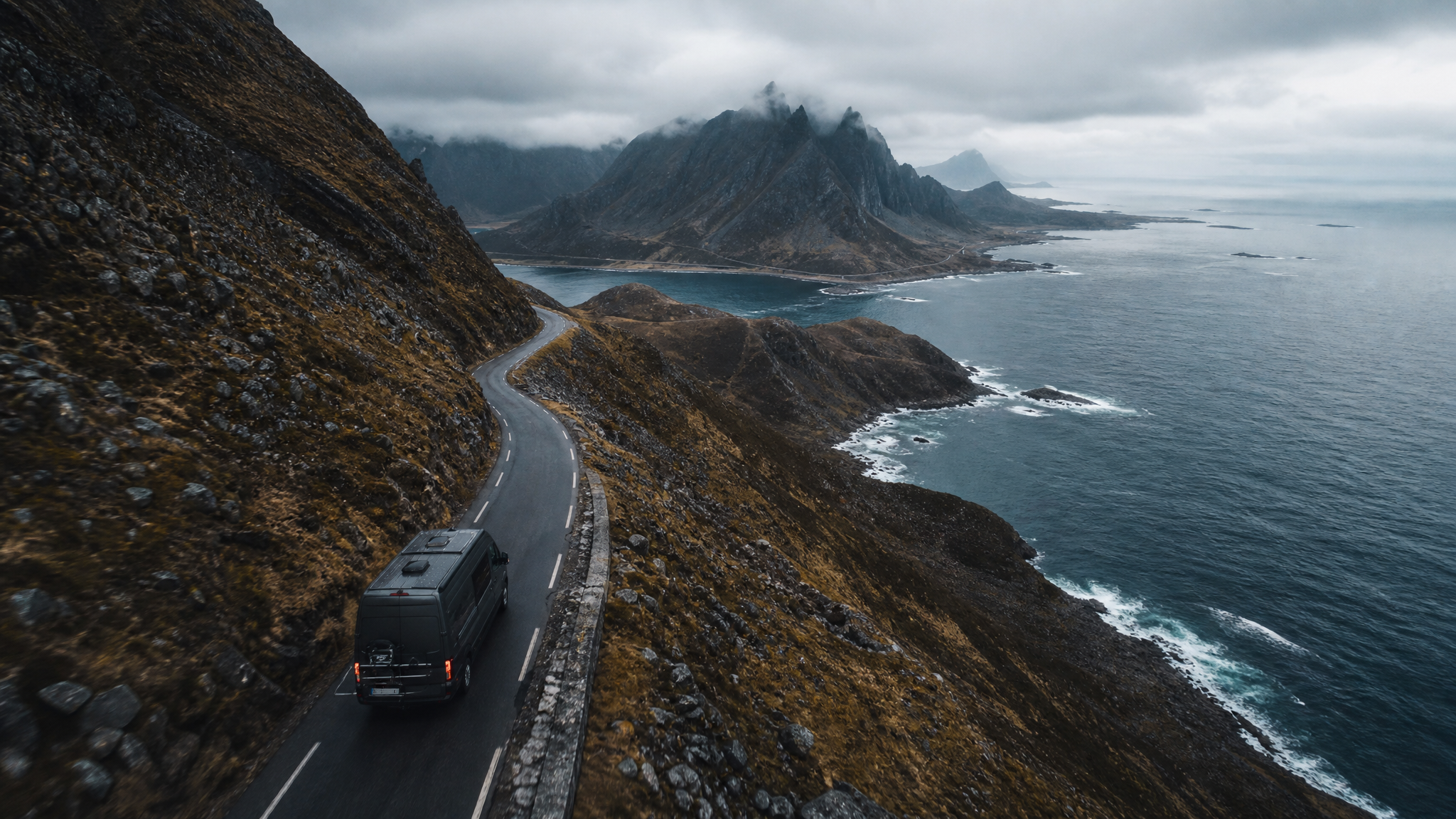 Aerial shot of van on remote mountain road