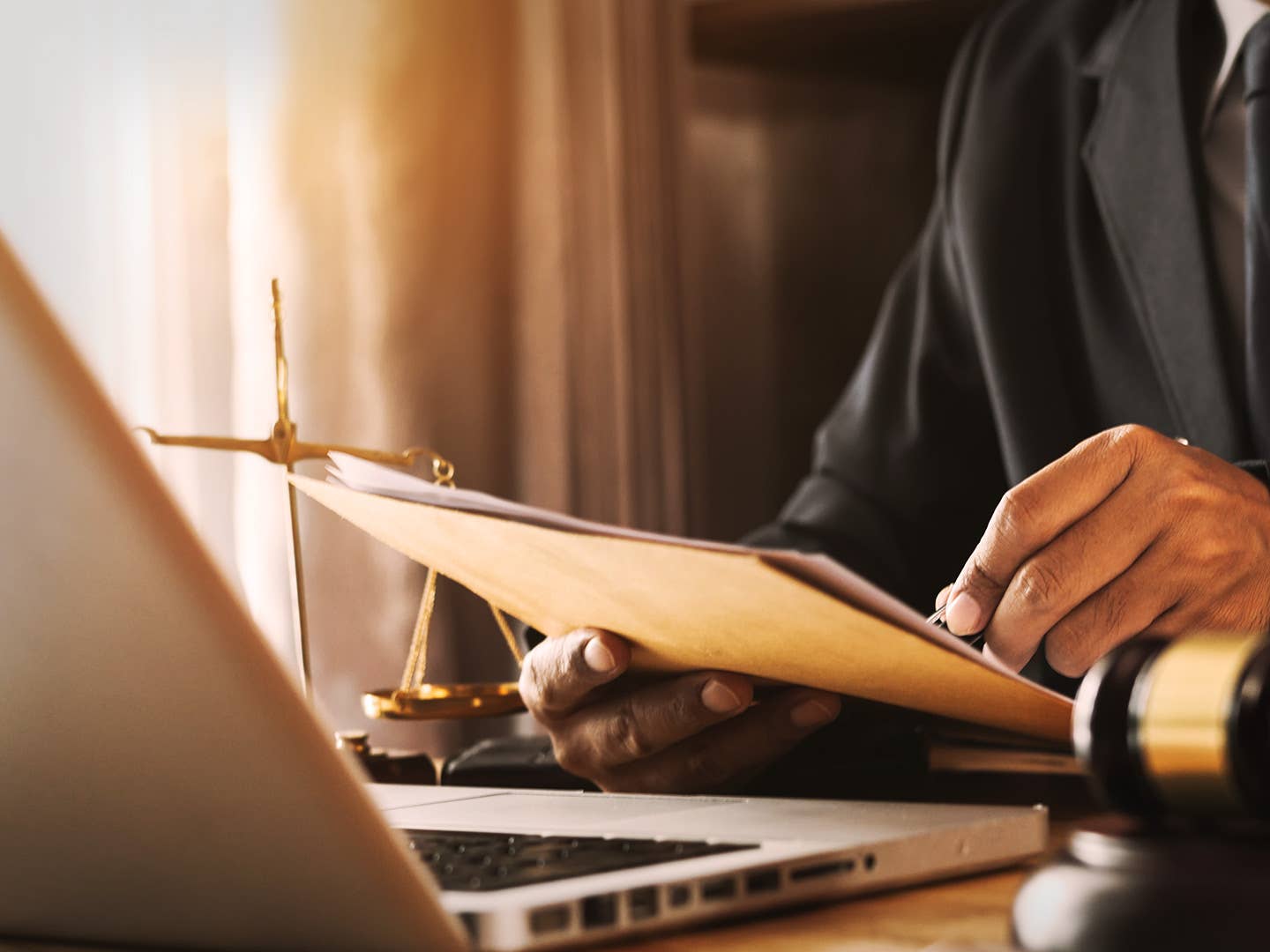 Real estate wholesaler reviewing property documents at desk