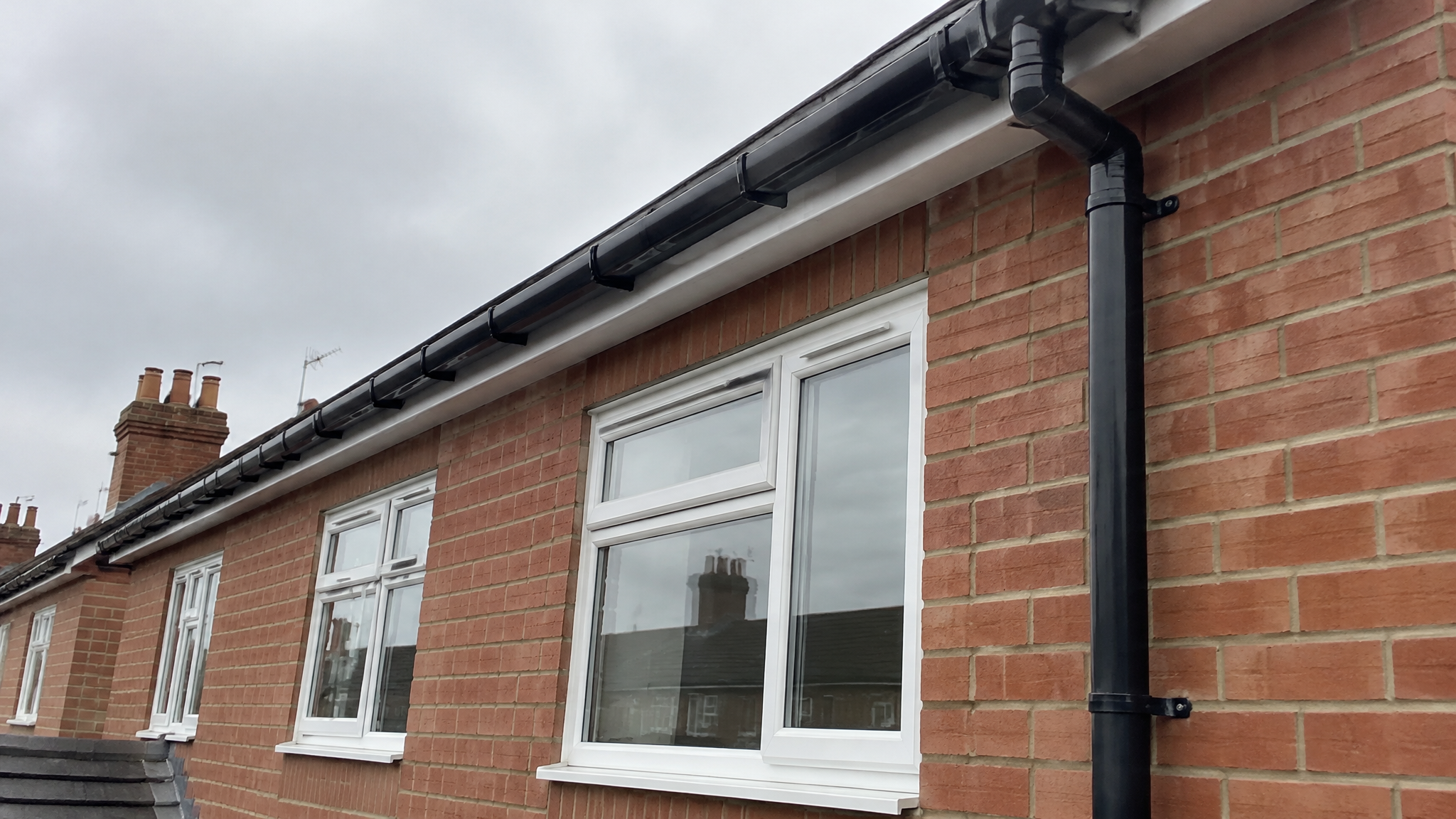 New black uPVC guttering on UK house