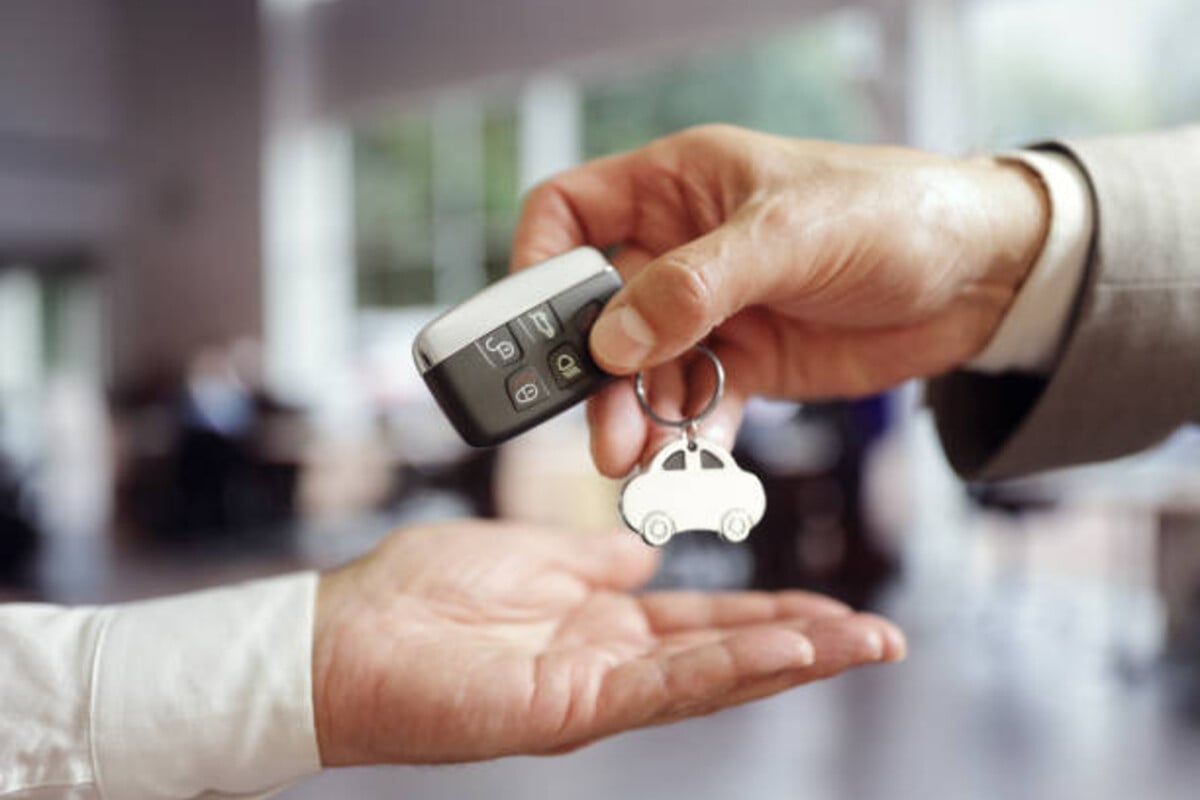Car keys being handed over during cash for cars transaction