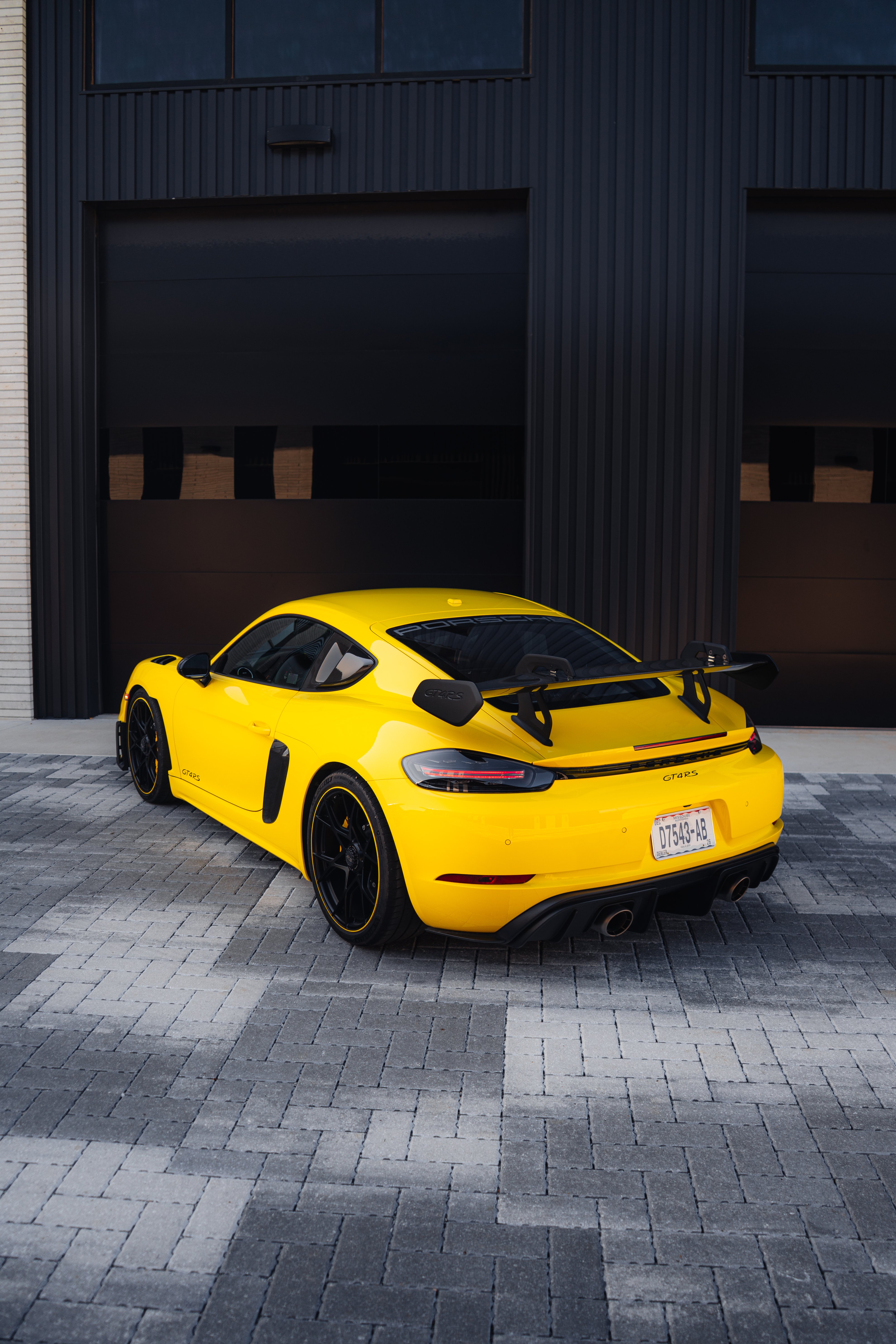2023 Porsche GT4 RS rear three-quarter with carbon fiber wing