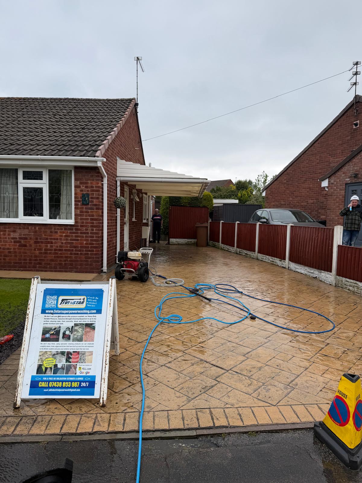 Stamped concrete driveway before cleaning - weather staining visible