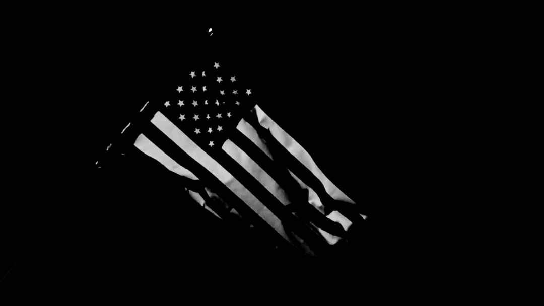 American flag with dramatic lighting representing military service and honor