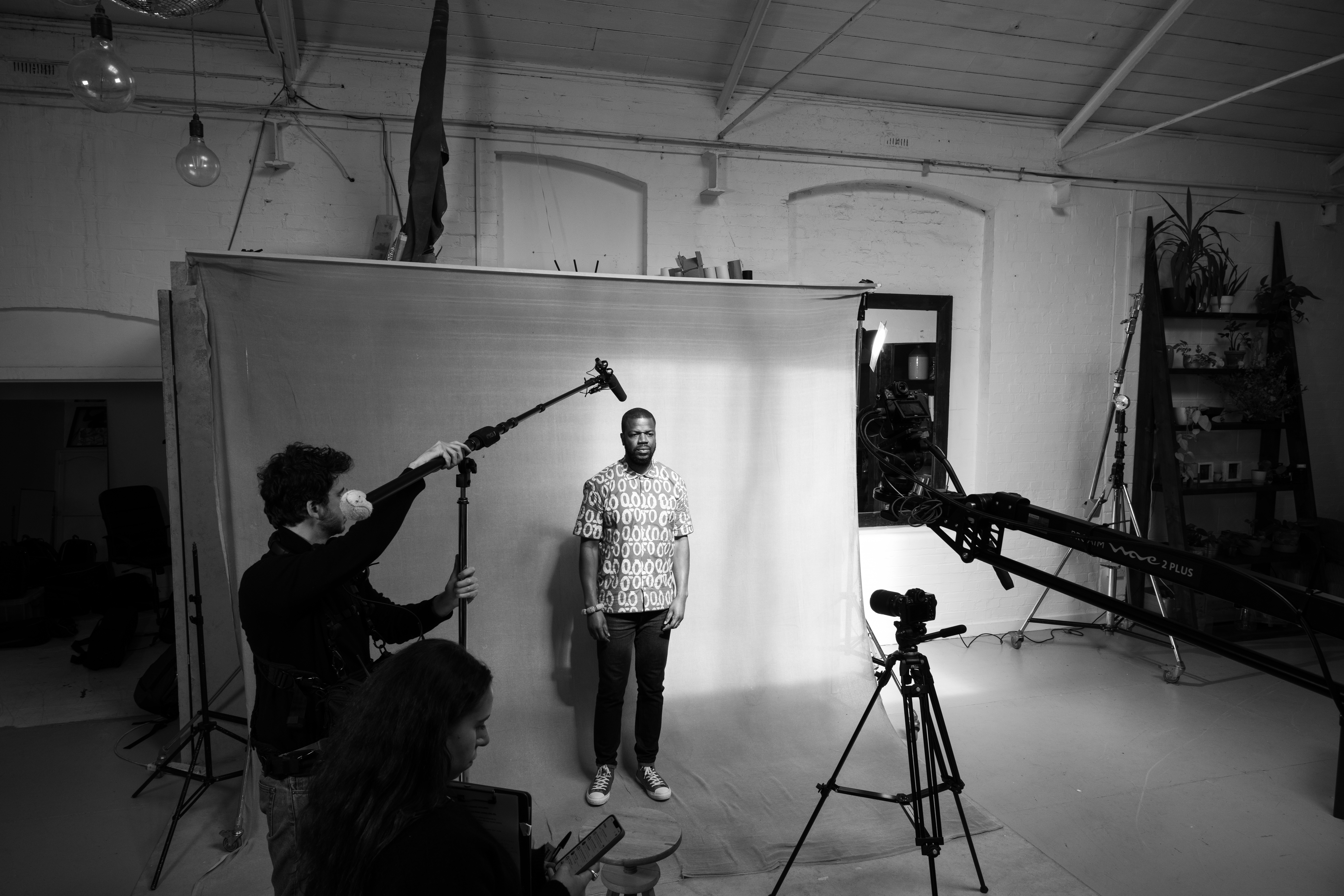 Behind the scenes: boom operator and contributor on a studio backdrop