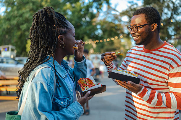 People enjoying food at an outdoor festival celebration