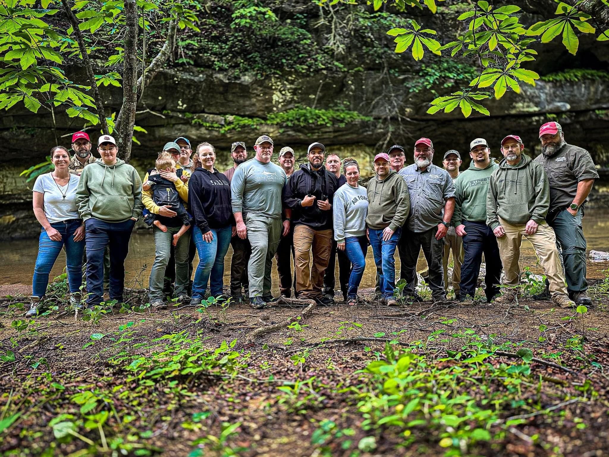 Camp Hero group of veterans and first responders gathered by rock formation in the Appalachian Mountains