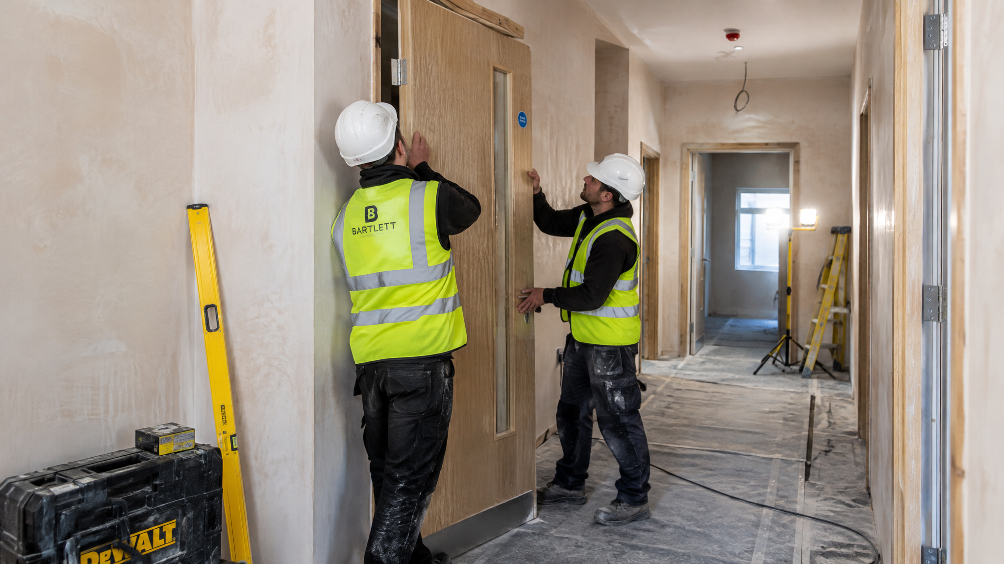 T Brown installer fitting a fire doorset