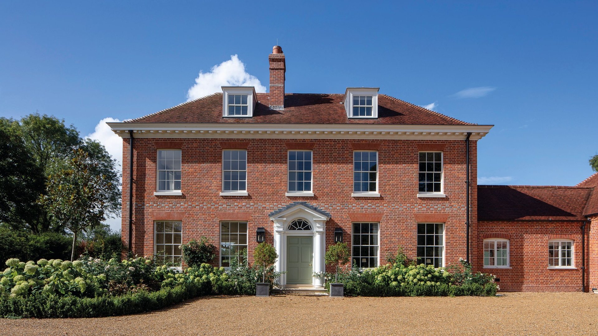 Professional UK roofing team working on residential house