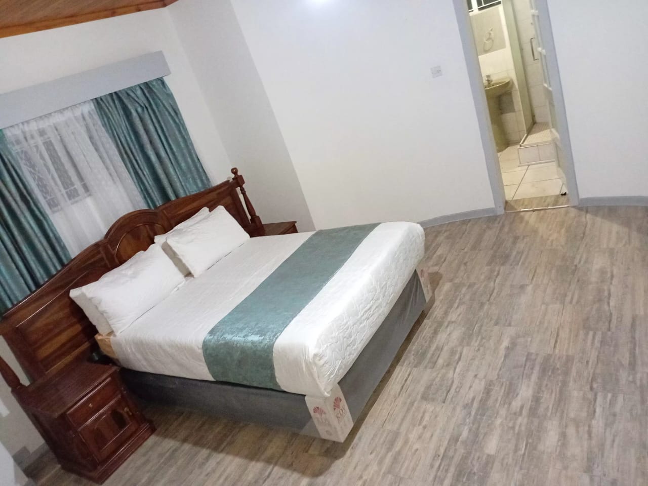 Bedroom with en-suite bathroom view at The Little Den