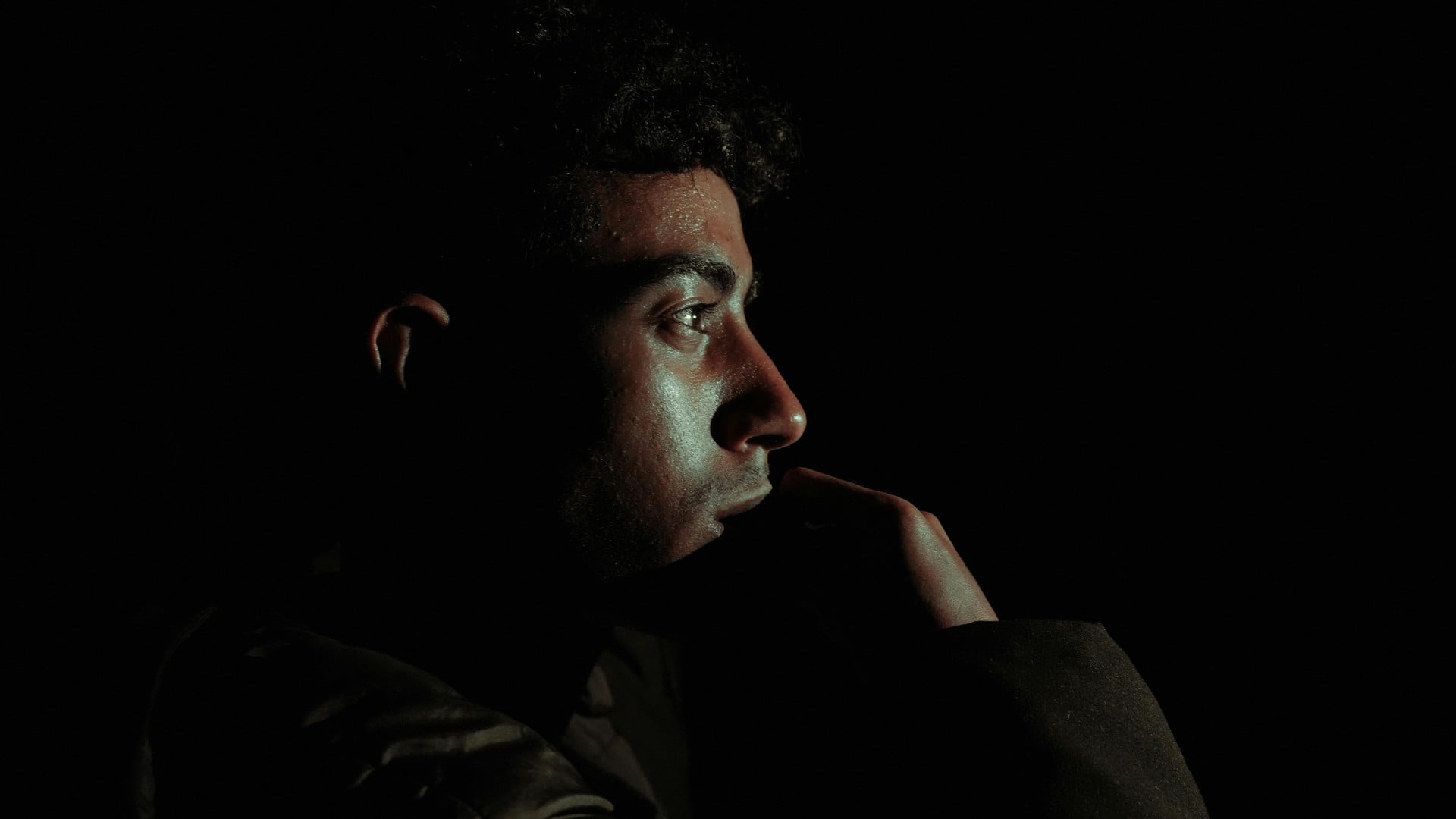Man in deep focus with dramatic side lighting