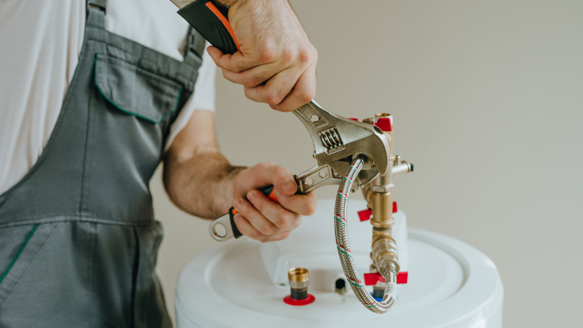 Water heater tank being flushed to remove hard water sediment buildup
