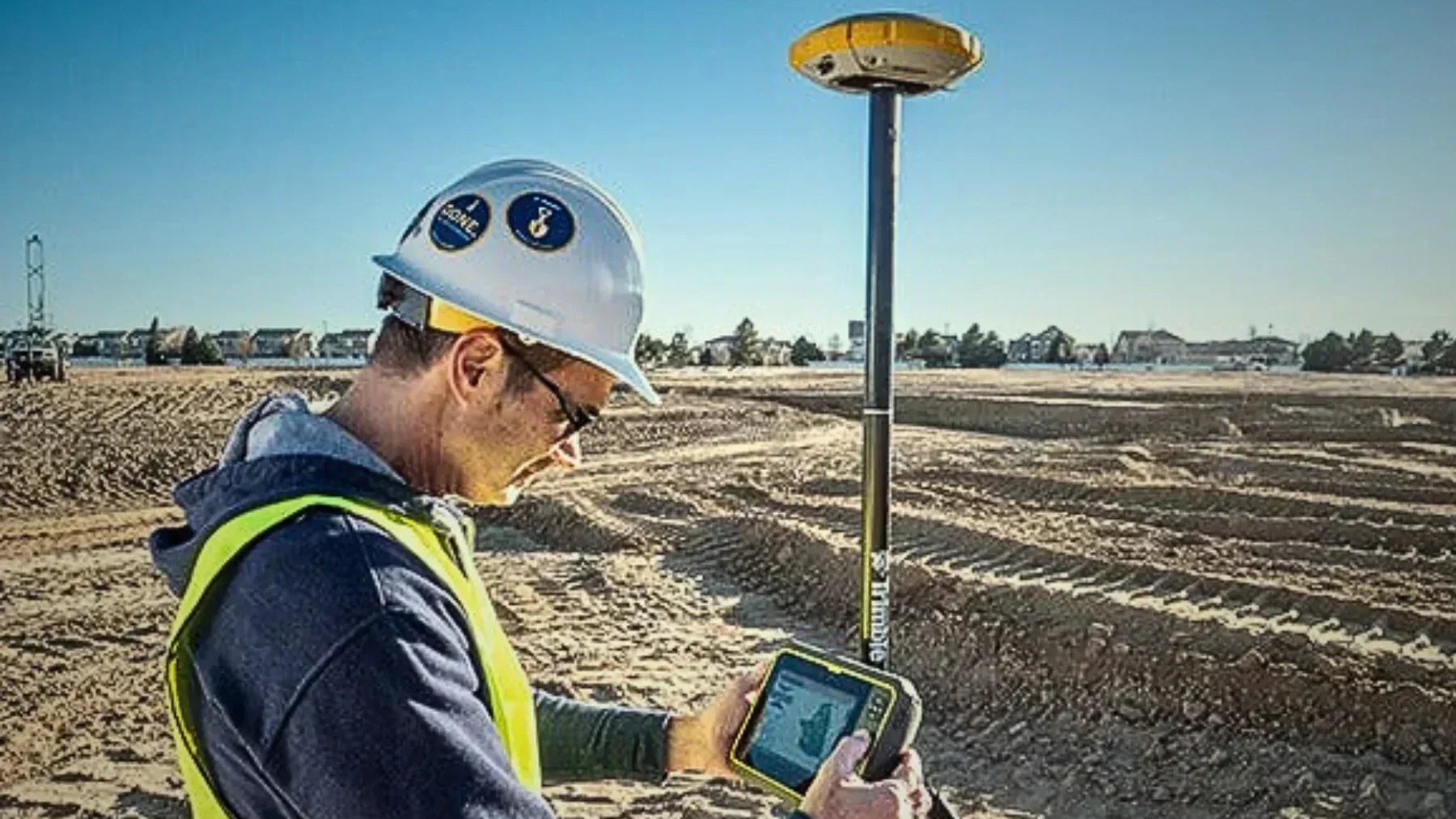 Professional surveyor performing topographic measurements with GNSS equipment