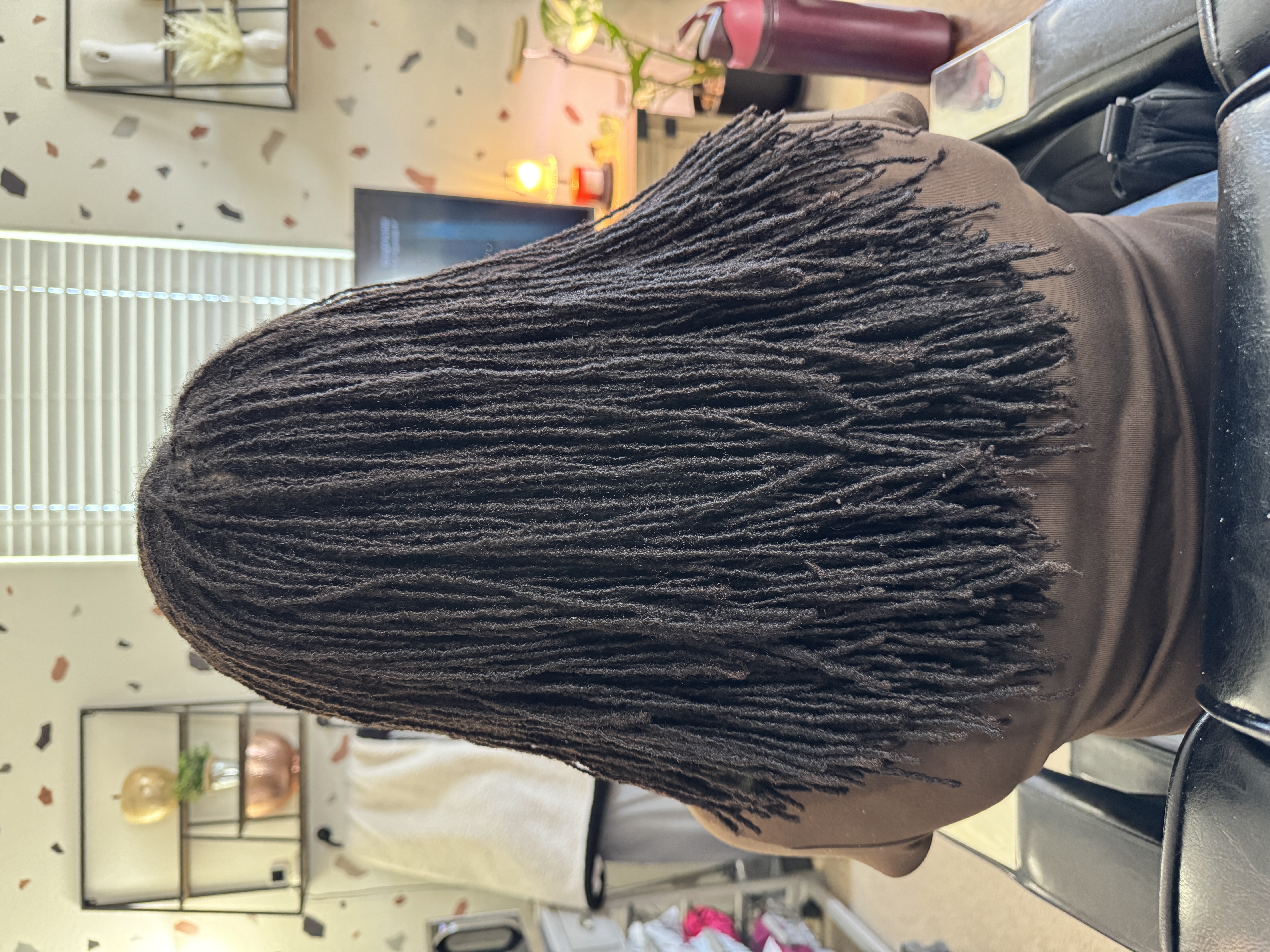 Freshly retightened natural dark microlocks with clean parting and healthy shine by CandieLocks
