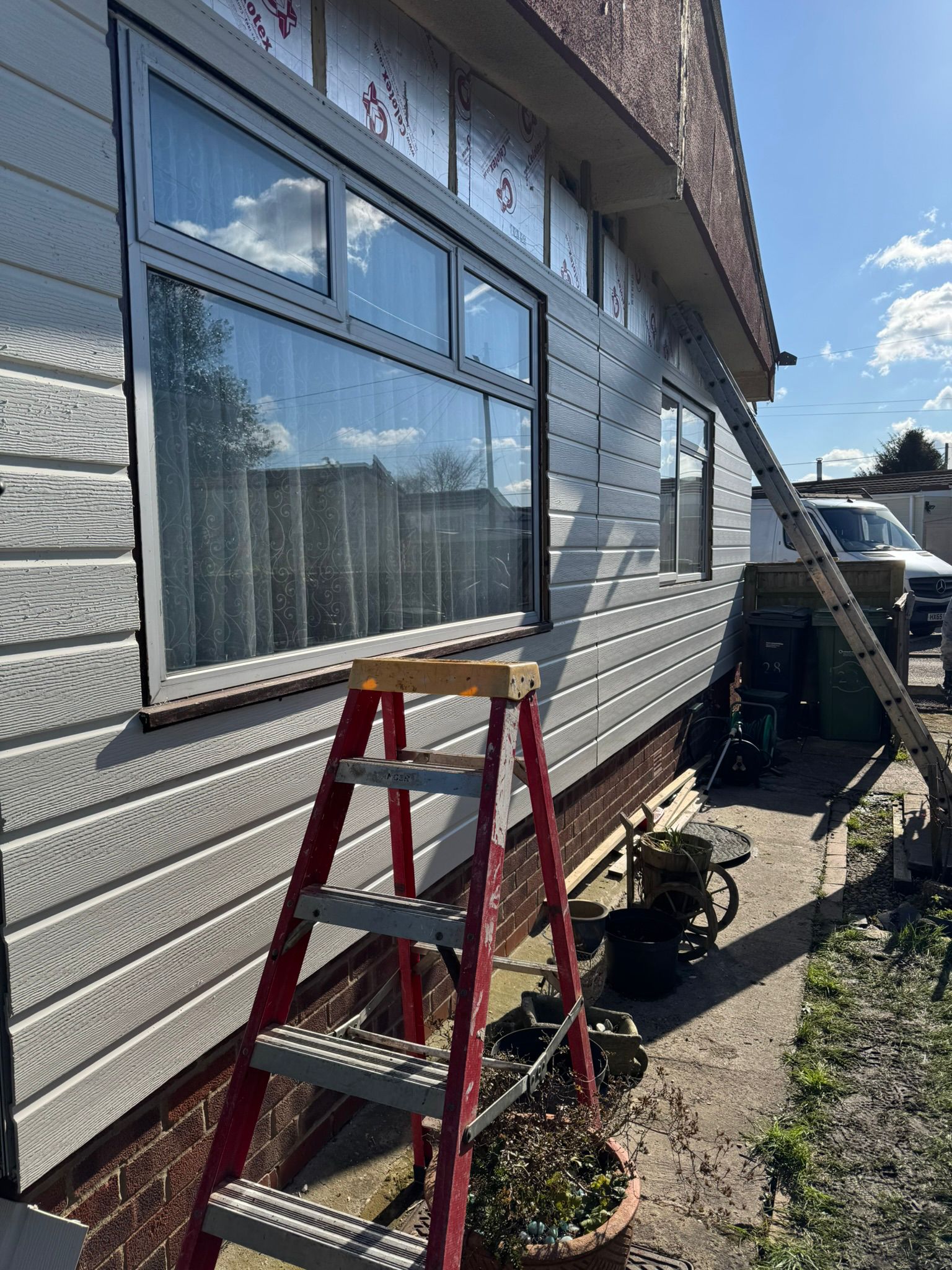 New windows fitted on park home with cladding and insulation visible