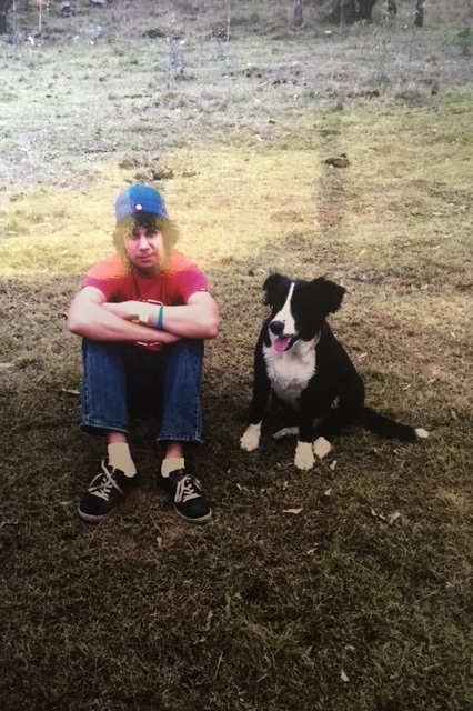 Young person from MADYACA Life Skills program with dog at campsite showing program activities