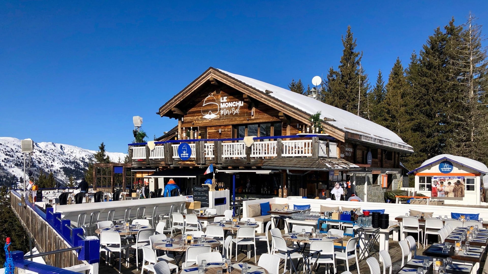 Le Monchu mountain restaurant terrace in Méribel with diners and mountain views
