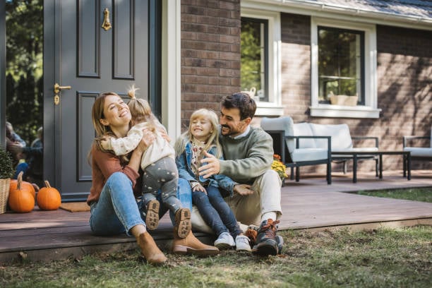 Happy family representing personal insurance coverage for home and auto