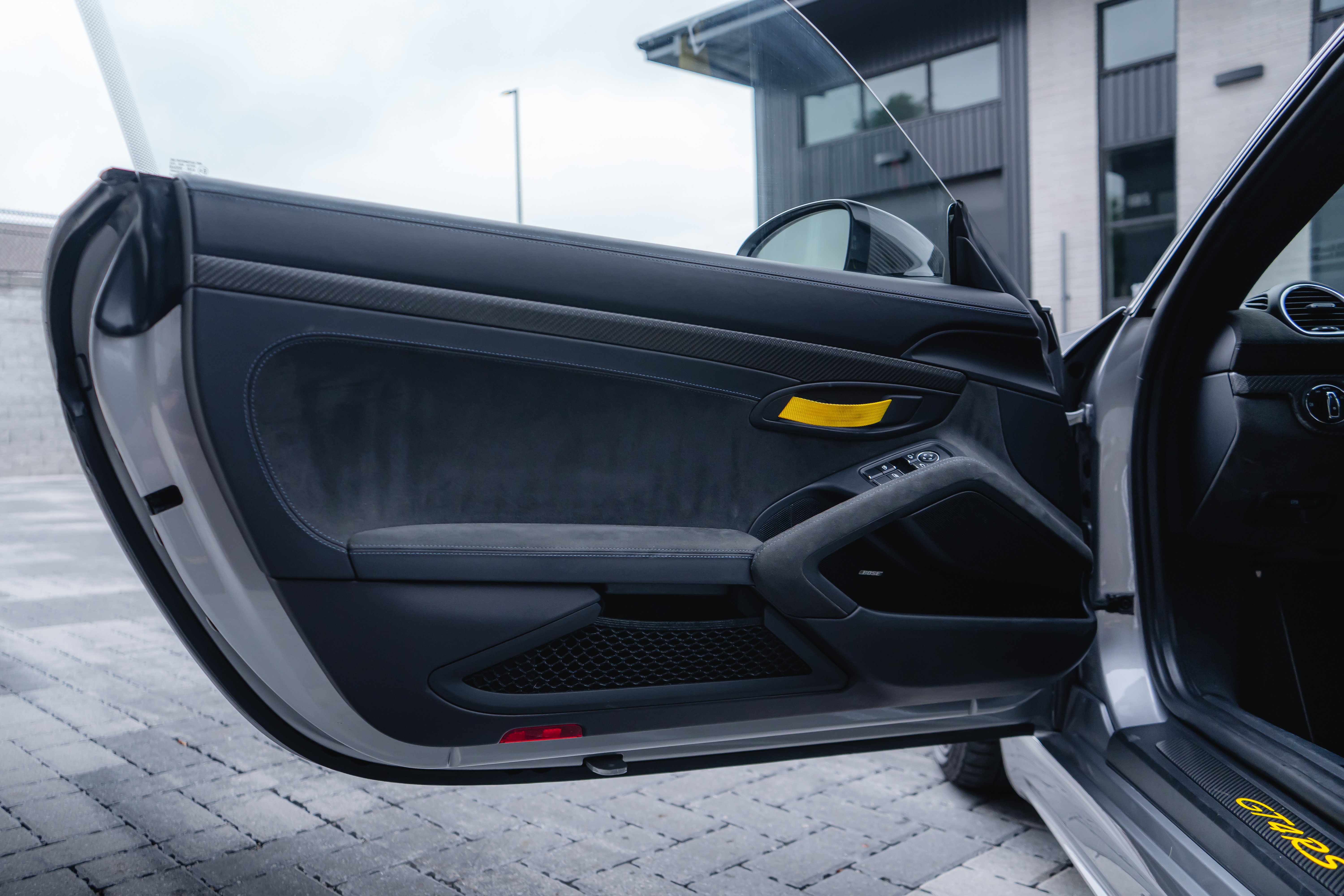 2023 Porsche GT4 RS front three-quarter view showing carbon fiber Weissach hood