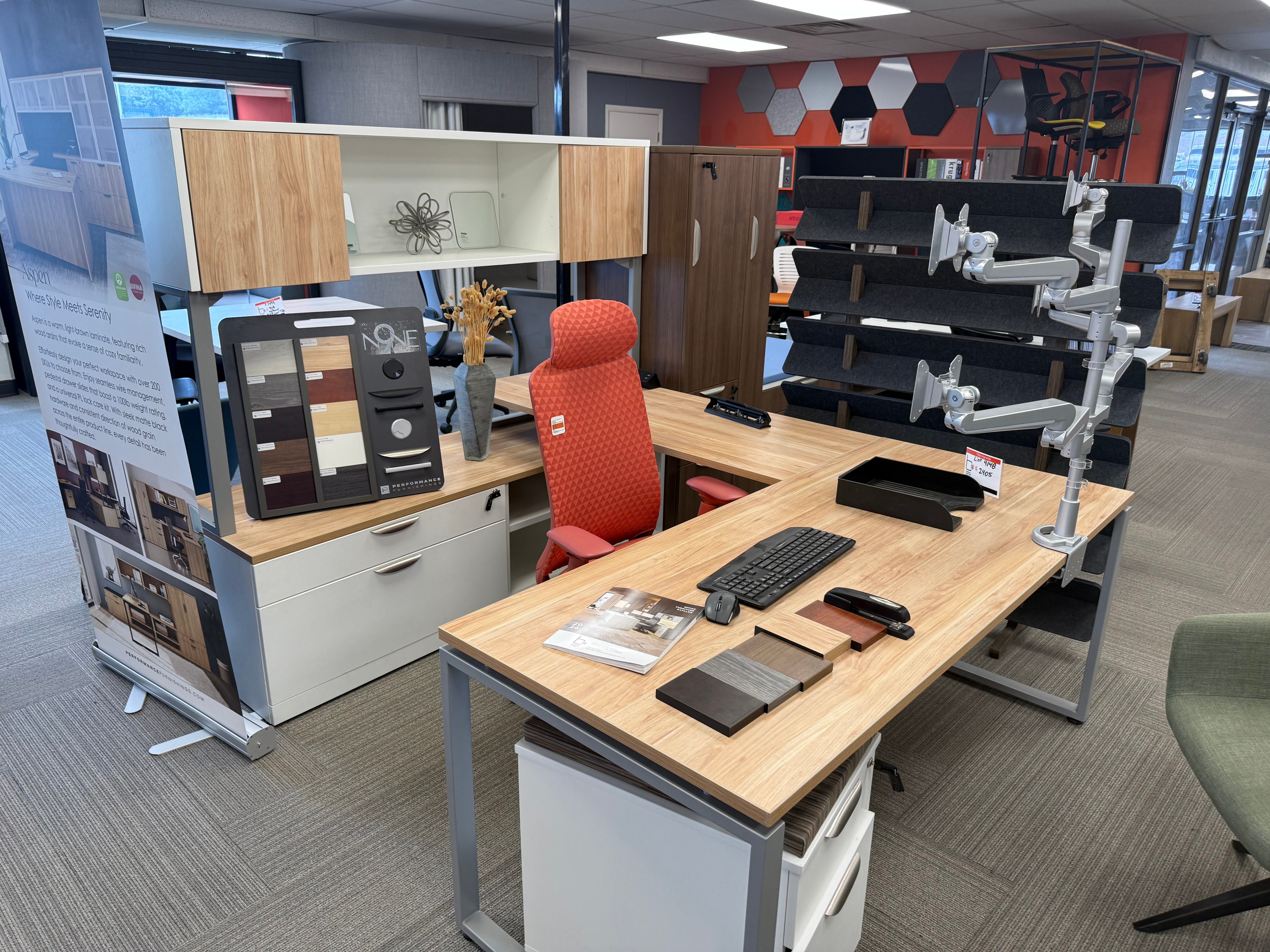 BFS showroom executive desk setup with ergonomic chair and monitor arms