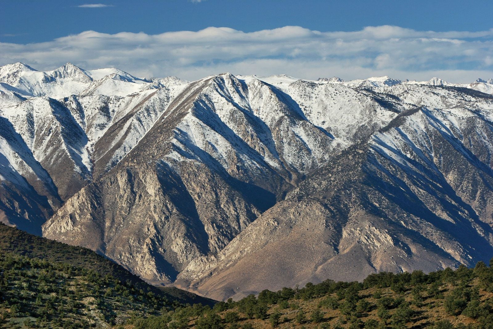 Steep fault-block mountain range rising abruptly from a valley