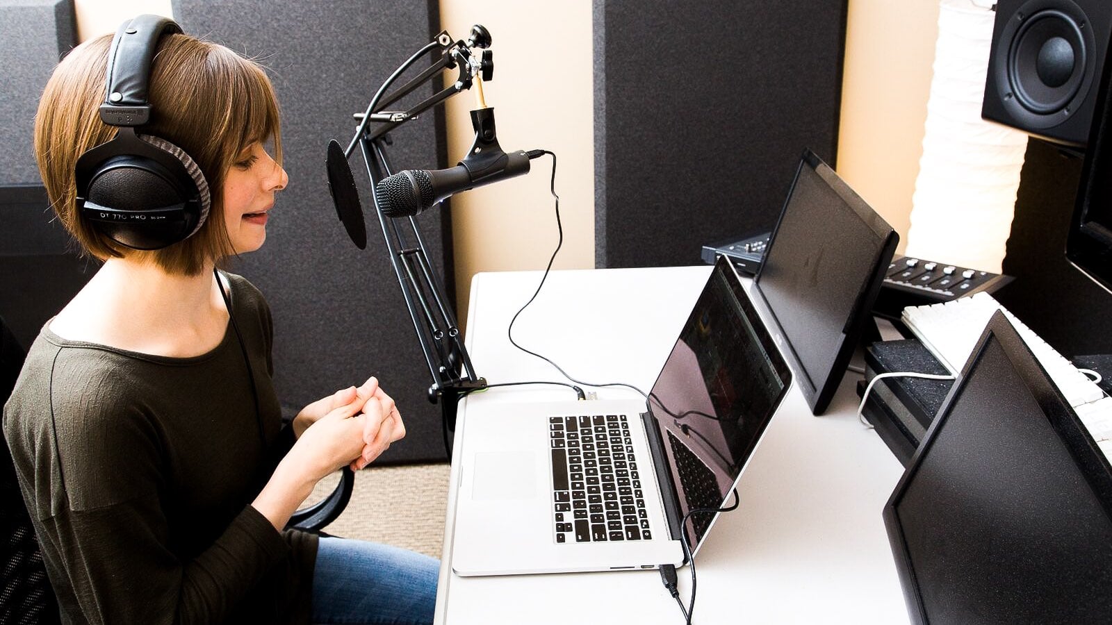 Professional podcaster recording in a studio with FaithSource equipment