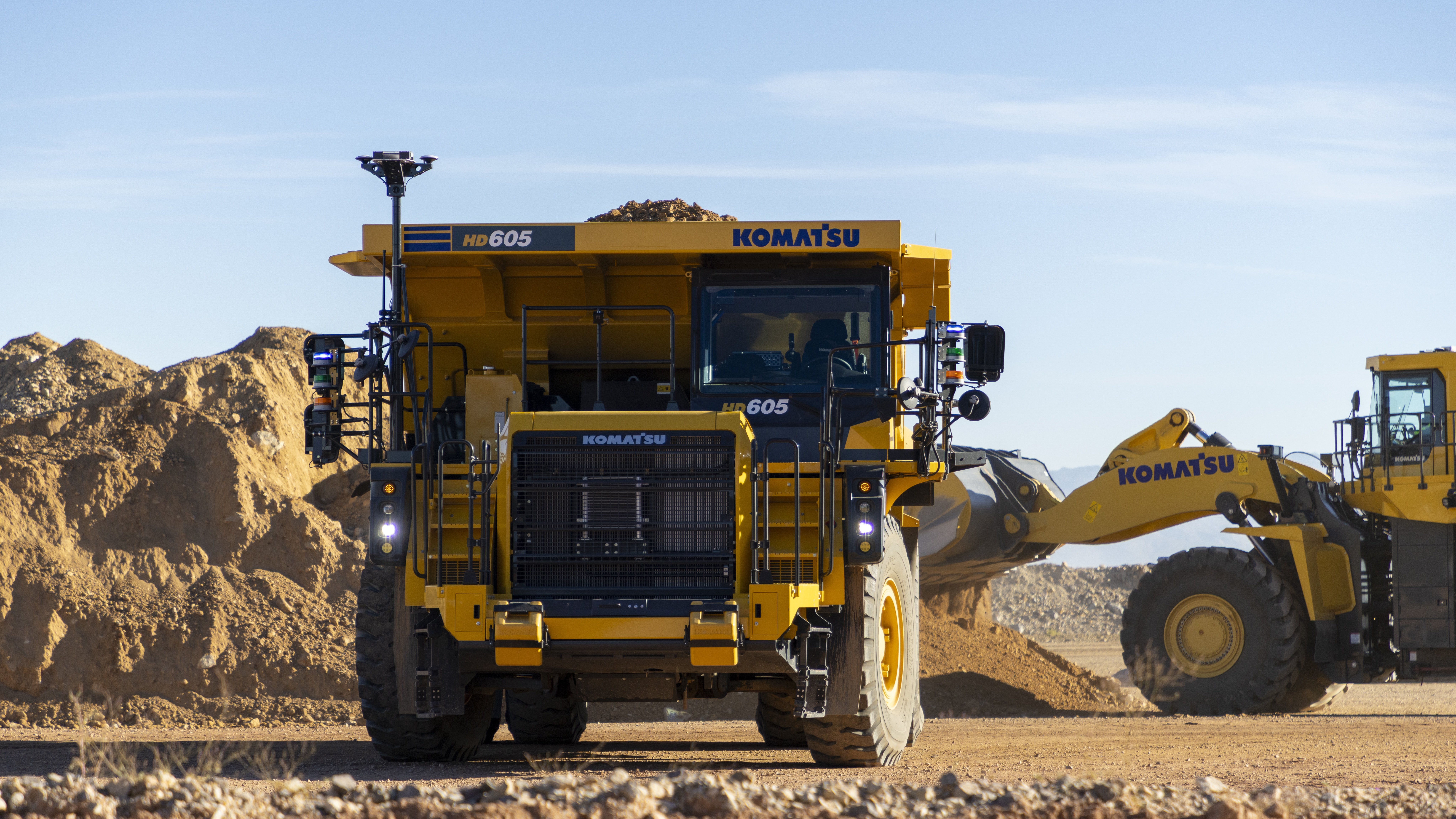 Modern gold mining operation with haul truck and loader