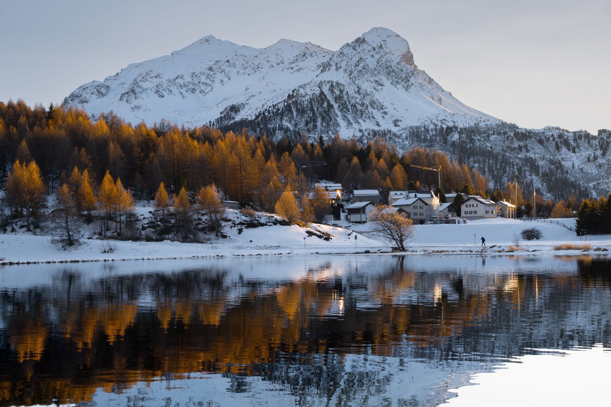 St. Moritz village with frozen lake and mountains in winter