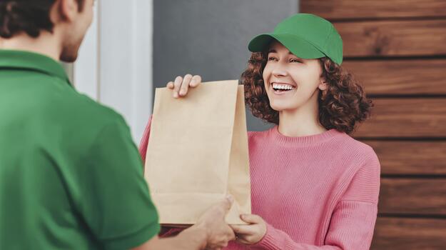 Courier delivering a package to a satisfied customer at their doorstep