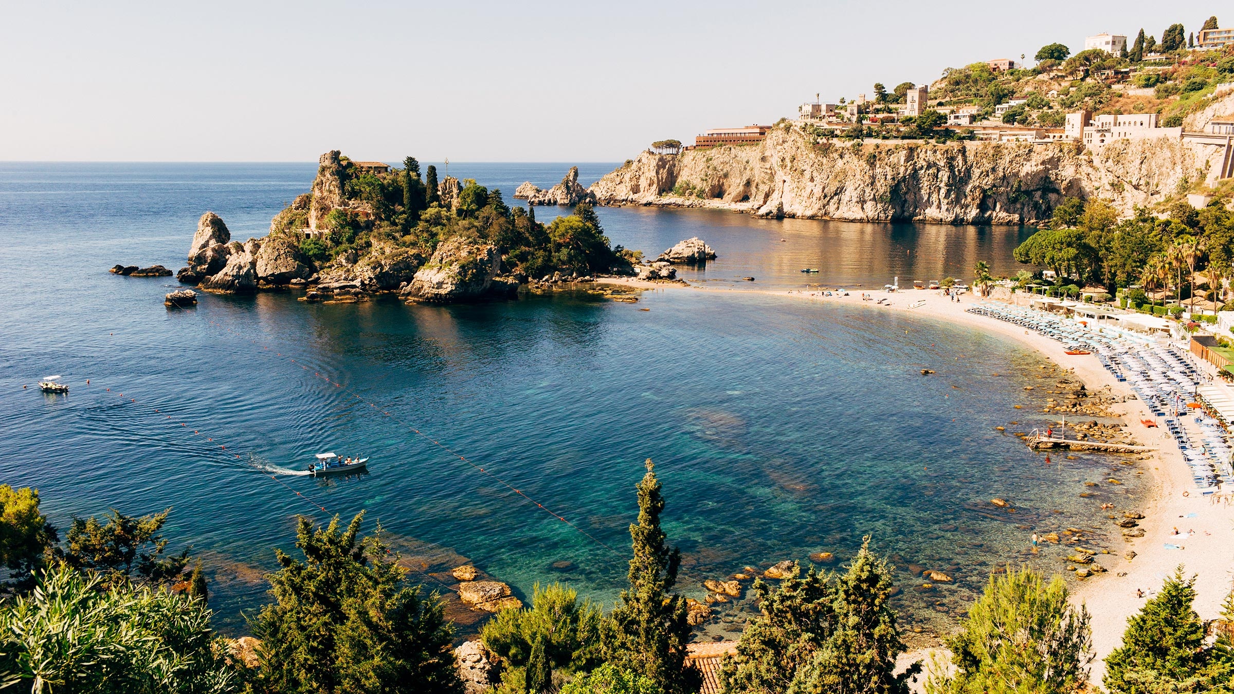 Dramatic Taormina coastline with cliffs and blue Mediterranean sea