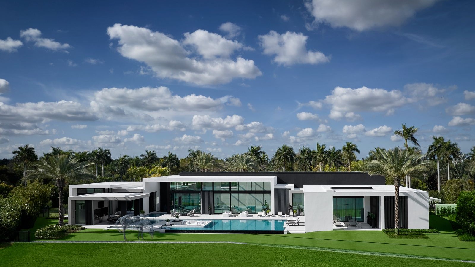 Luxury modern mansion in South Florida with palm trees and pool