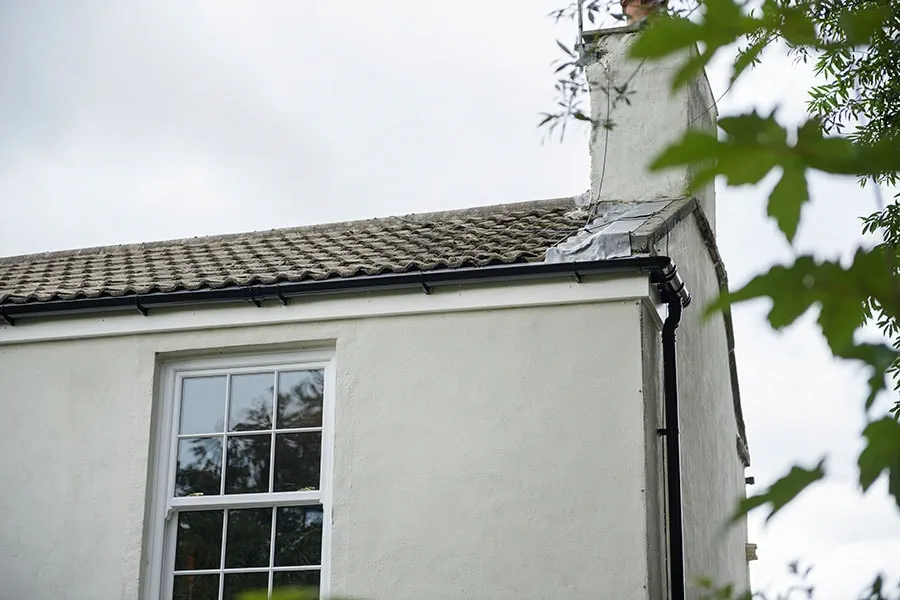 Black guttering and downpipe