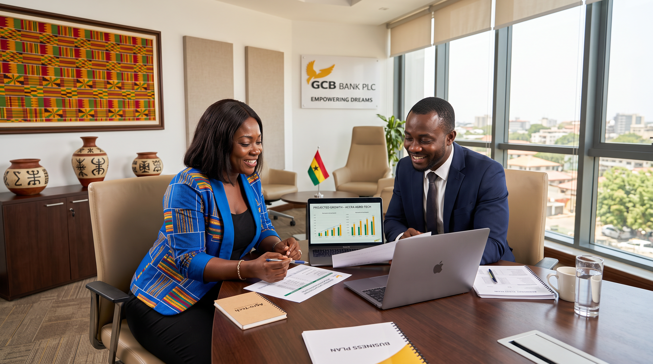 A Ghanaian business owner and a loan officer reviewing financing documents together in a bright, modern bank office with Kente-inspired wall art