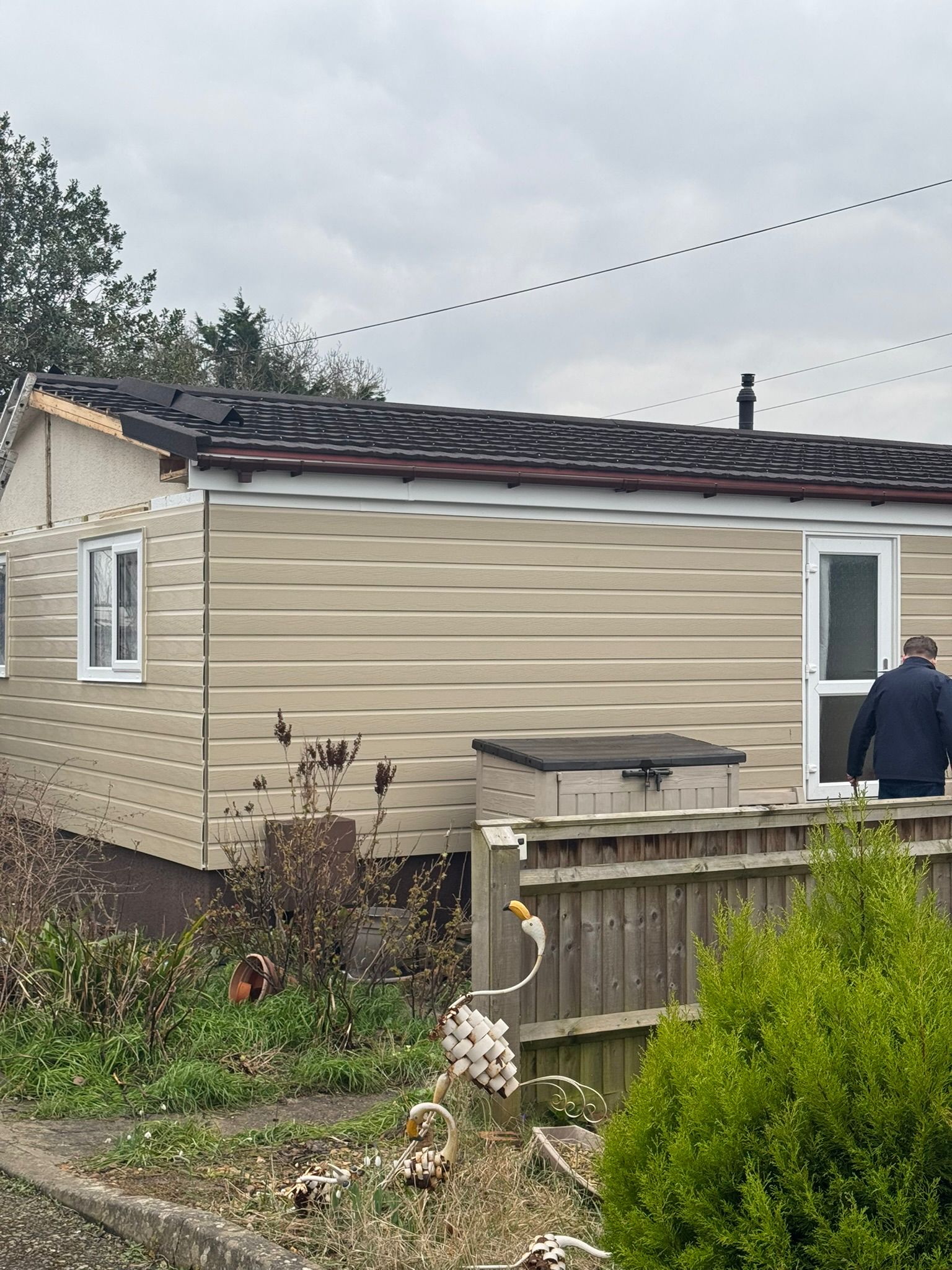 Park home with completed new cladding and roof renovation from side angle
