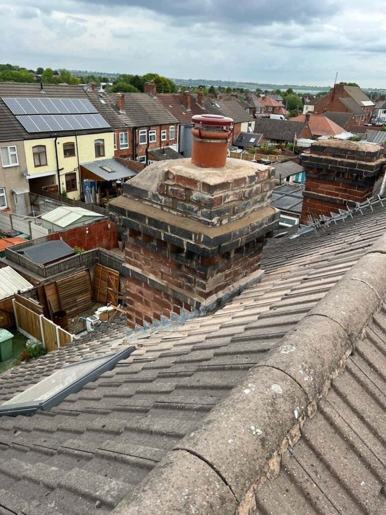 Roof repair in progress, chimney flashing work