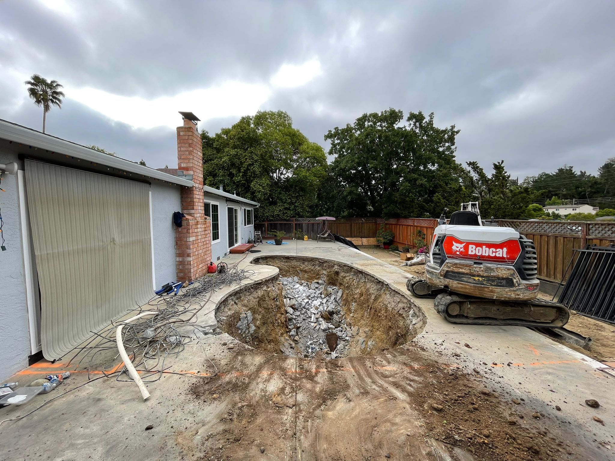 Bobcat Breaking Pool Concrete