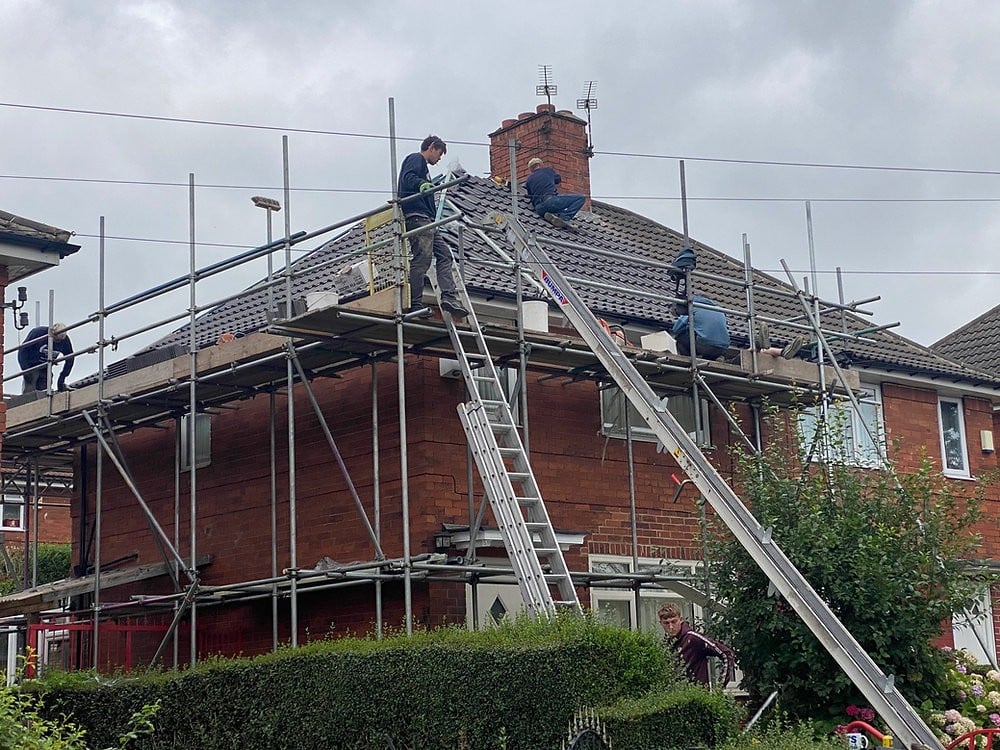 Professional roofer from Safe Guard working on a UK home