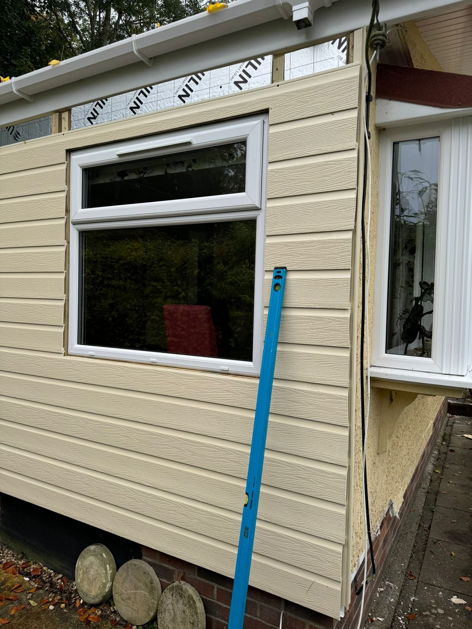 Park home cladding work in progress with partially completed wall sections