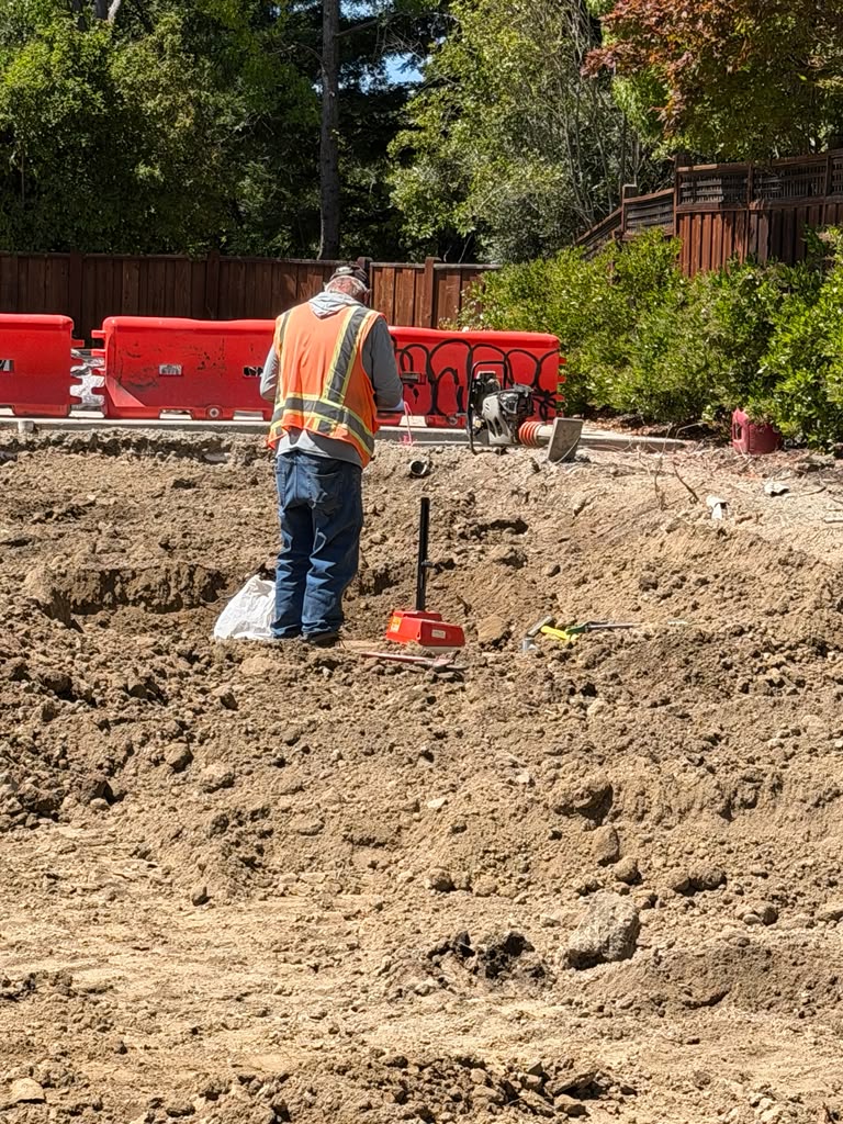 Worker Compacting Graded Soil