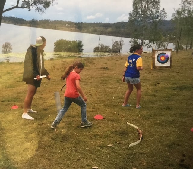 Dr. Schultz leading archery activities with young people at MADYACA programs