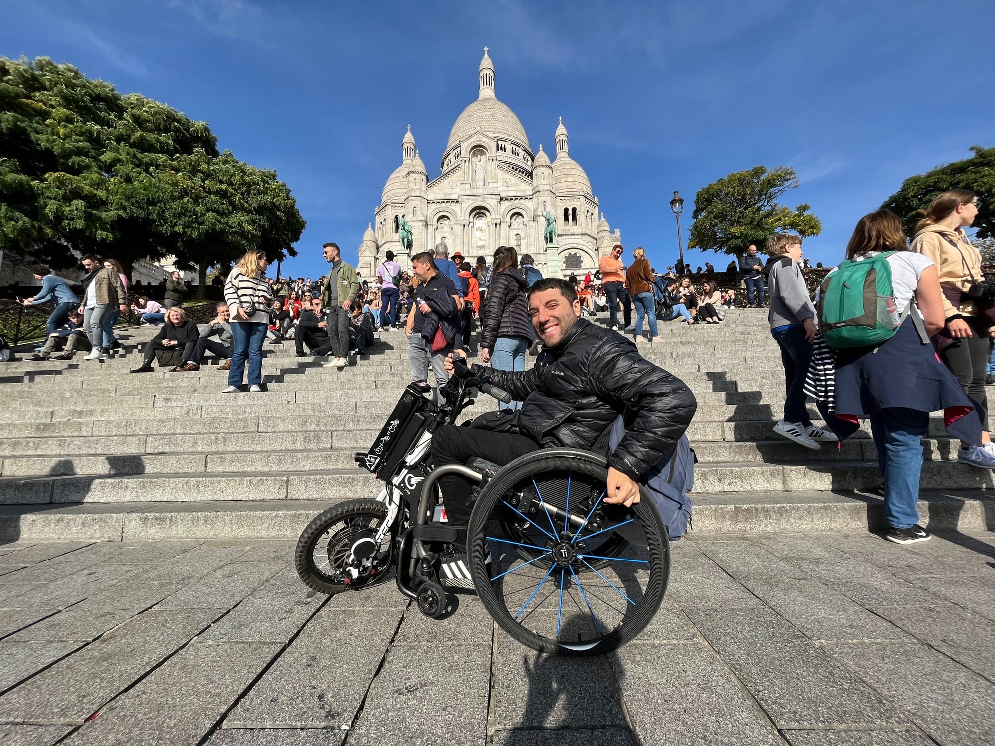 Happy wheelchair user arriving at destination in urban setting