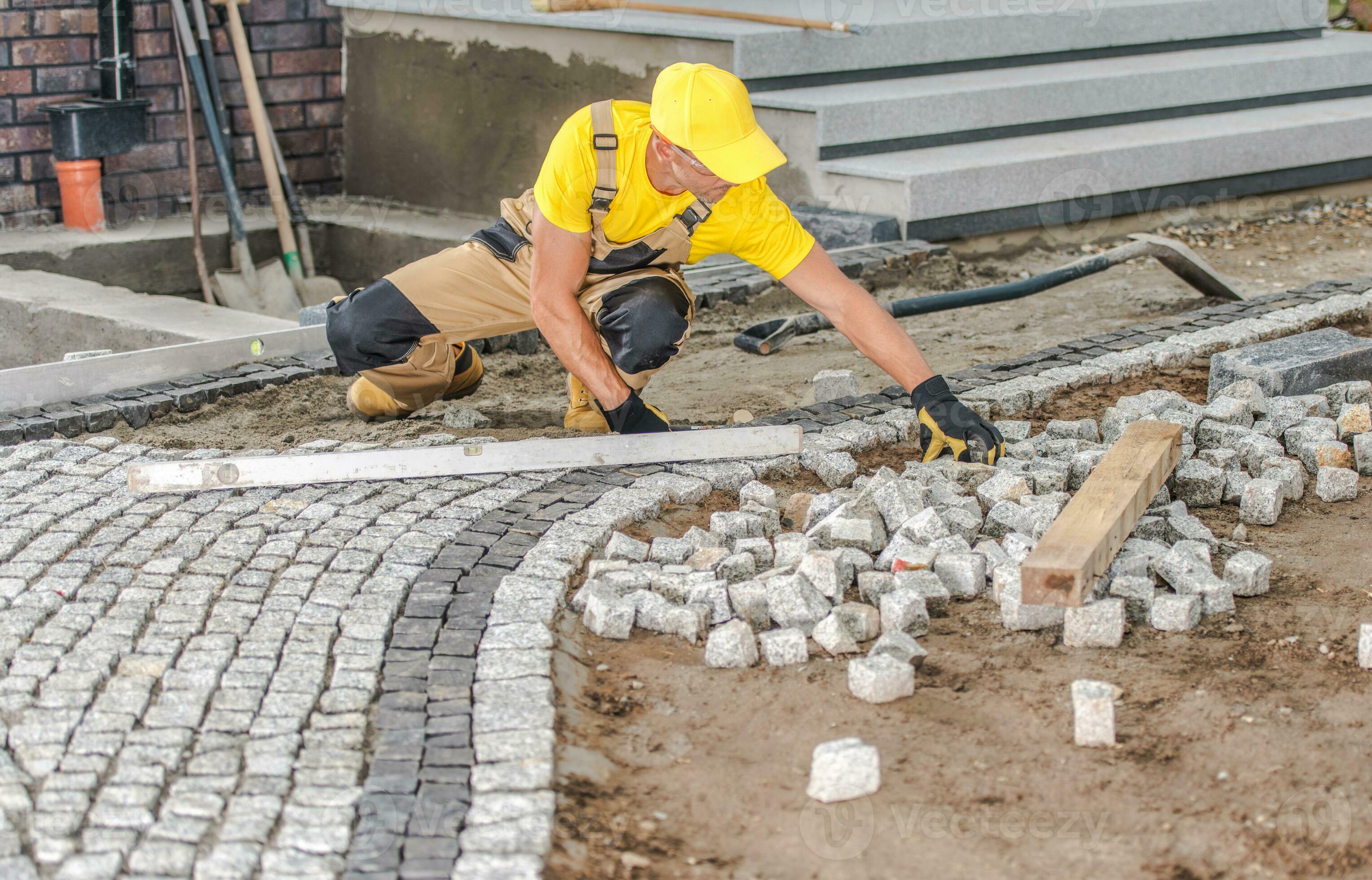 Professional team laying block paving