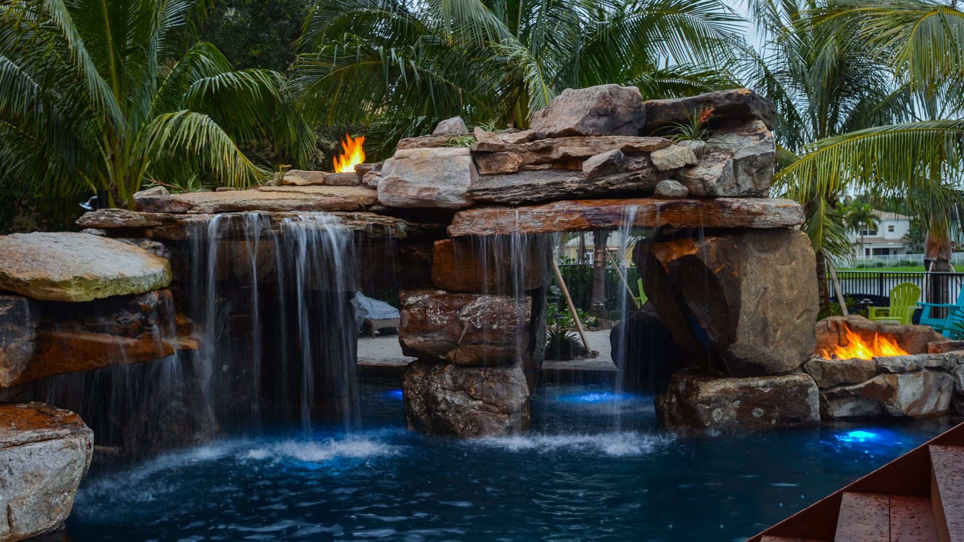 Resort-style pool with waterfall and tropical landscaping