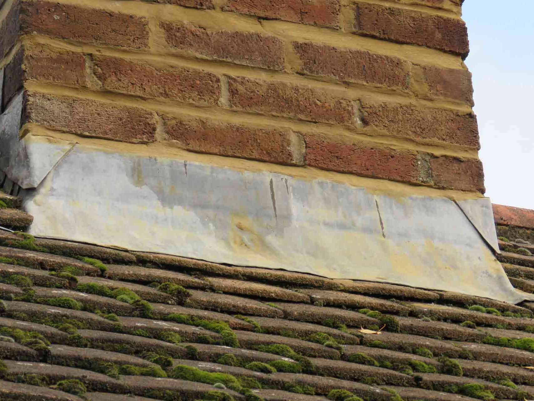 Damaged lead flashing around chimney