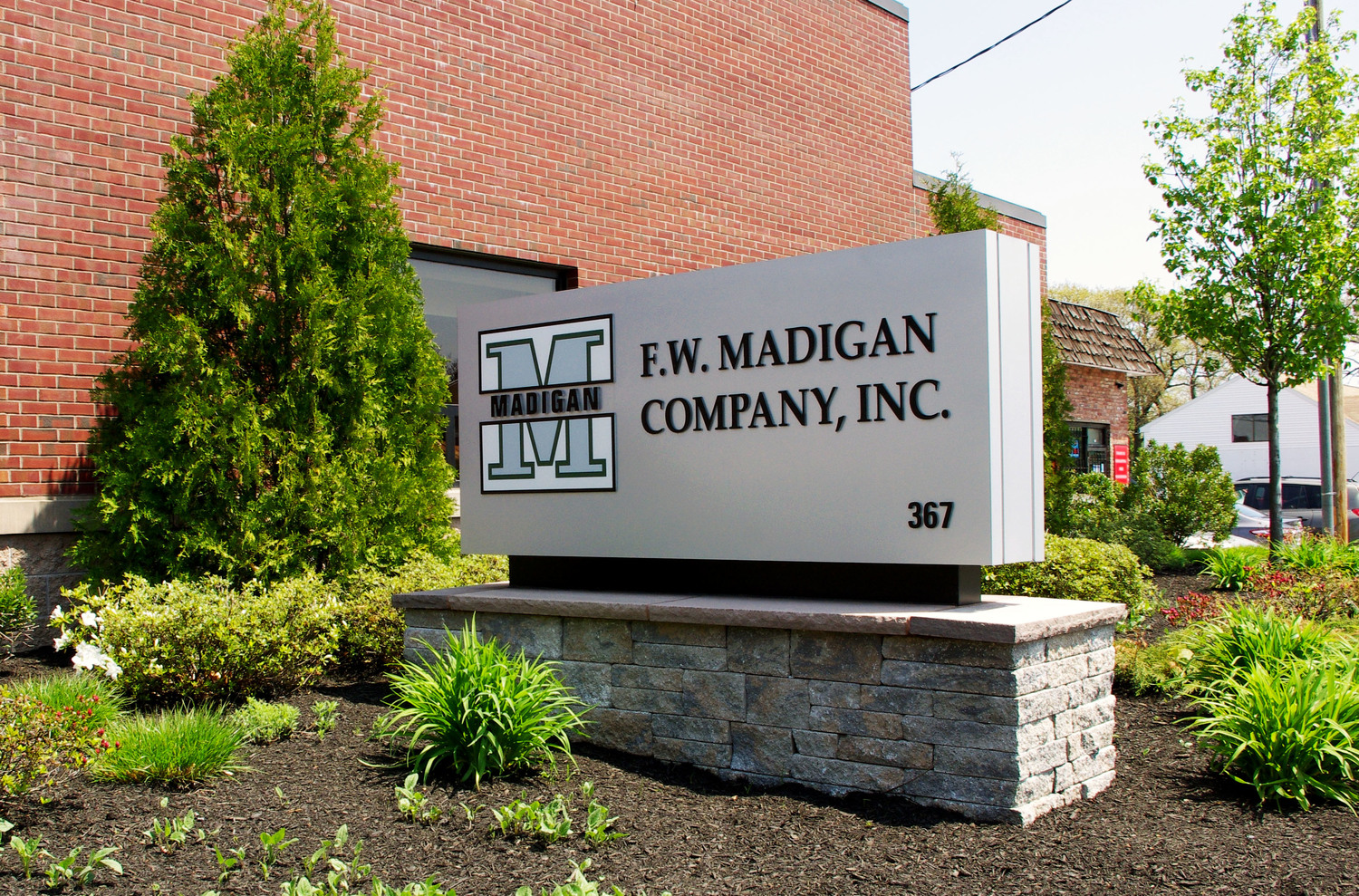 Large freestanding monument sign at commercial property entrance