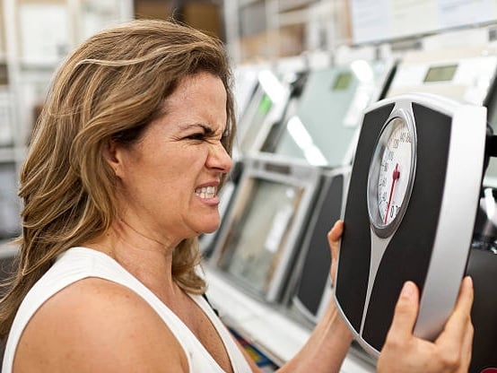 Woman frustrated with weight scale