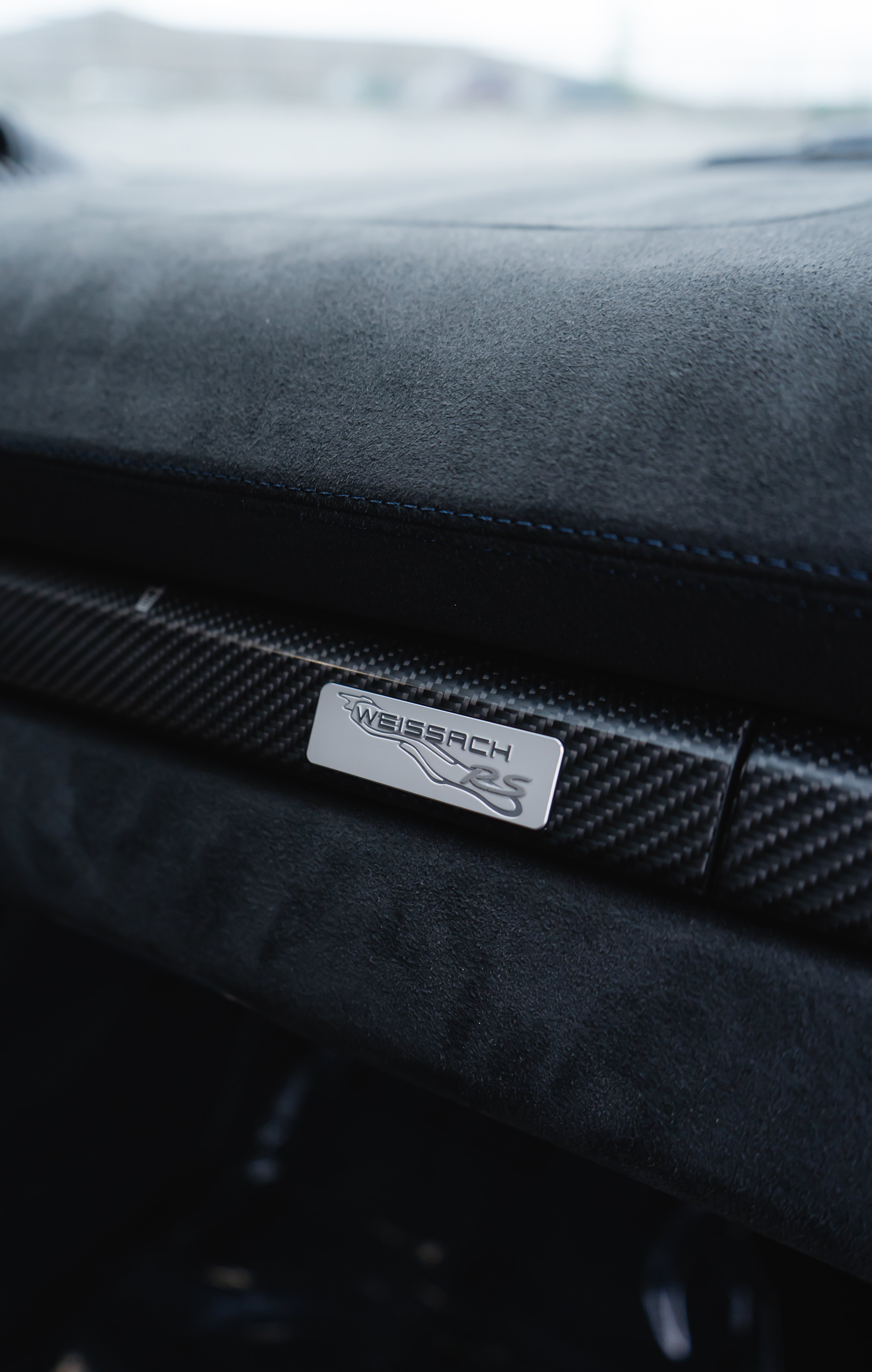 Weissach RS badge on carbon fiber Race-Tex dashboard