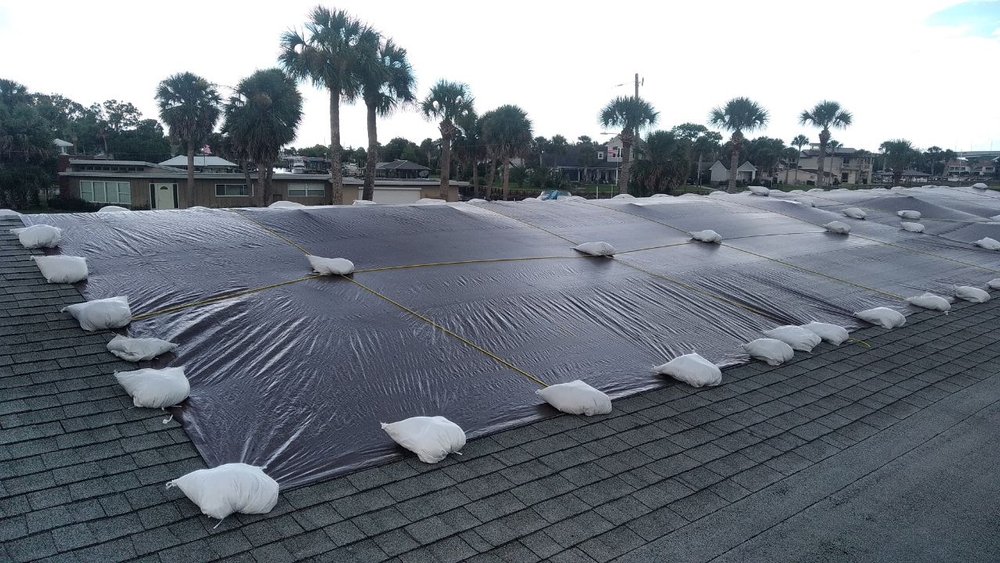 Emergency roof repair with tarpaulin cover
