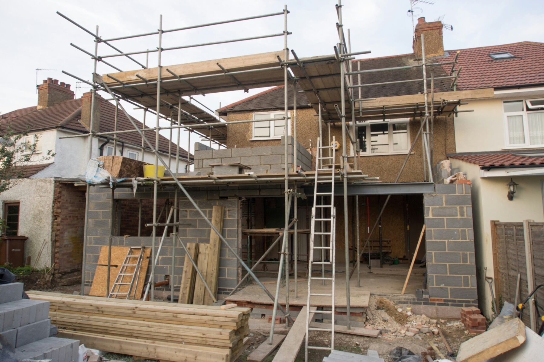 House extension under construction with scaffolding ready for a new roof